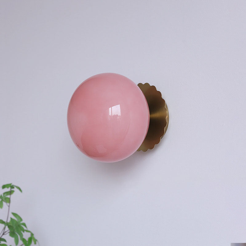 Modern, minimalist 1-light wall lamp made of iron glass with a round head in pink, beige, and white