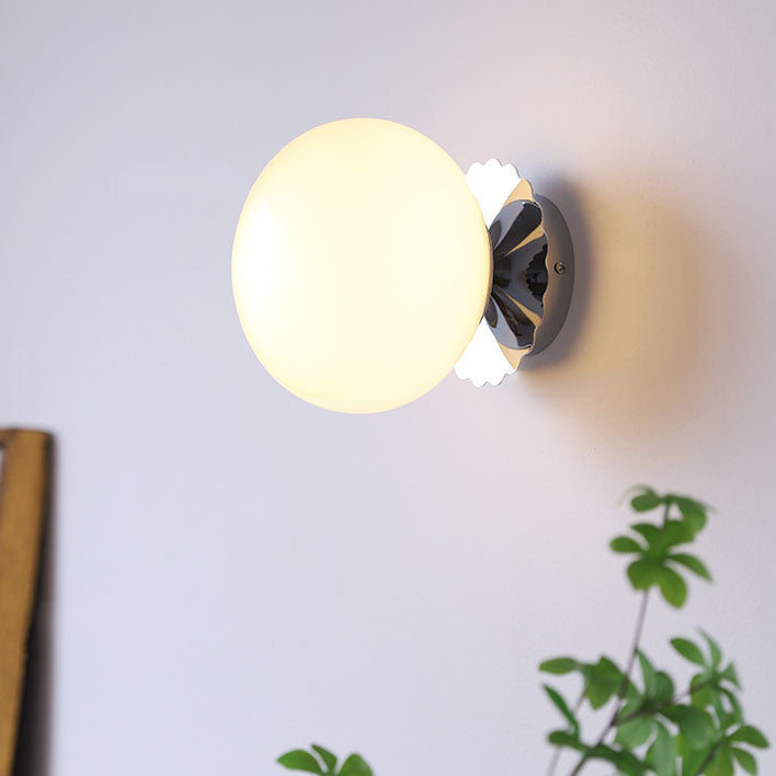 Modern, minimalist 1-light wall lamp made of iron glass with a round head in pink, beige, and white