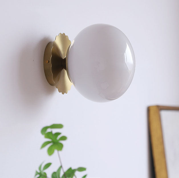 Modern, minimalist 1-light wall lamp made of iron glass with a round head in pink, beige, and white