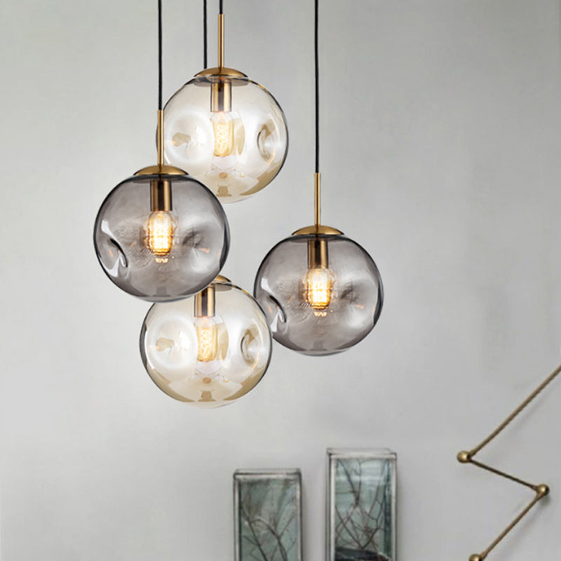 Dimpled Sphere Ceiling Pendant Modern Cognac/Smoke Grey Glass 1 Head Brass Hanging Light Fixture for Living Room Clearhalo 'Ceiling Lights' 'Glass shade' 'Glass' 'Modern Pendants' 'Modern' 'Pendant Lights' 'Pendants' Lighting' 1937208