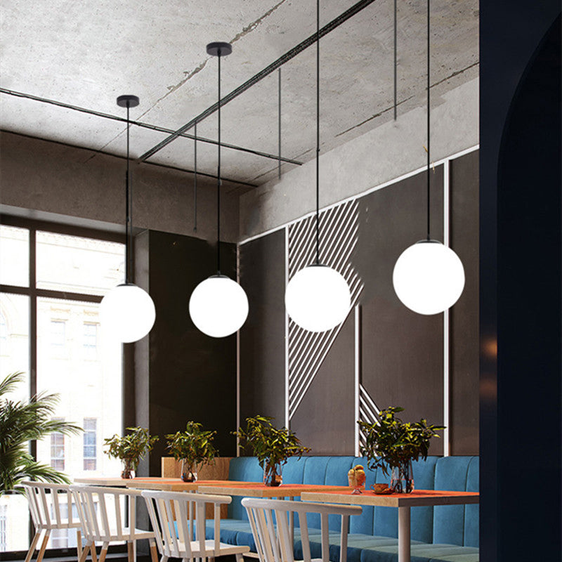 Sphere Restaurant Pendant Light Cream Glass 1 Head Simple Ceiling Hang Lamp in Black Clearhalo 'Ceiling Lights' 'Modern Pendants' 'Modern' 'Pendant Lights' 'Pendants' Lighting' 2356898