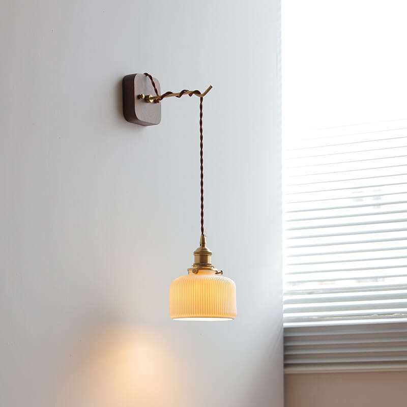 Japanese style ceramic wall lamp with copper arm and walnut canopy, featuring a modern design and white ceramic lampshade.