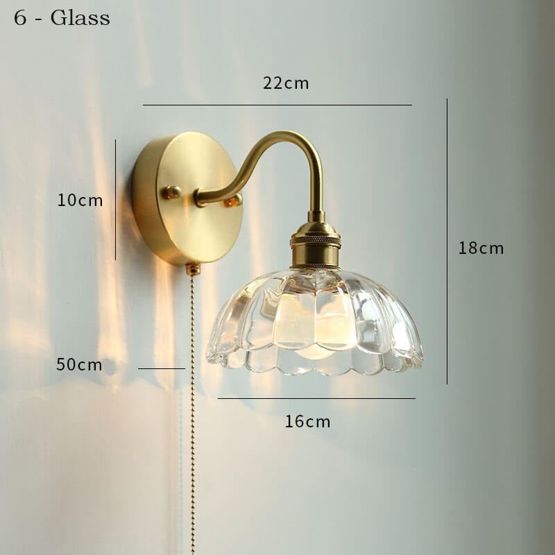 Ceramic adjustable wall lamp with pull chain switch, mounted on a copper fixture.