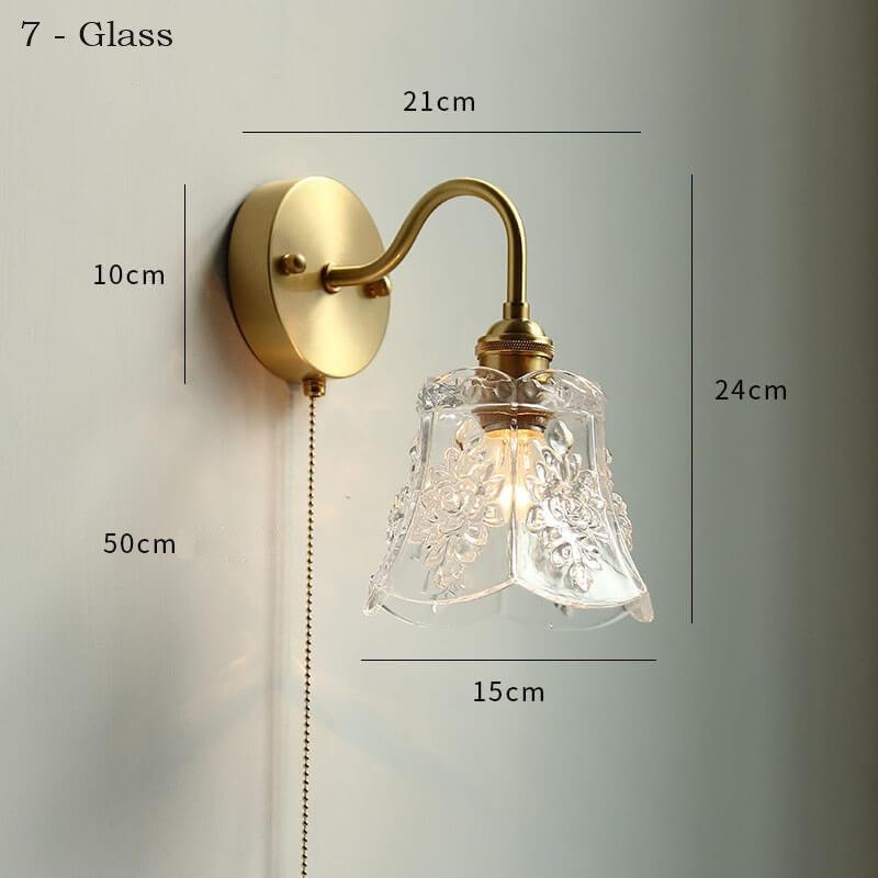 White ceramic wall lamp with pull chain switch, featuring a copper holder for durability and style.