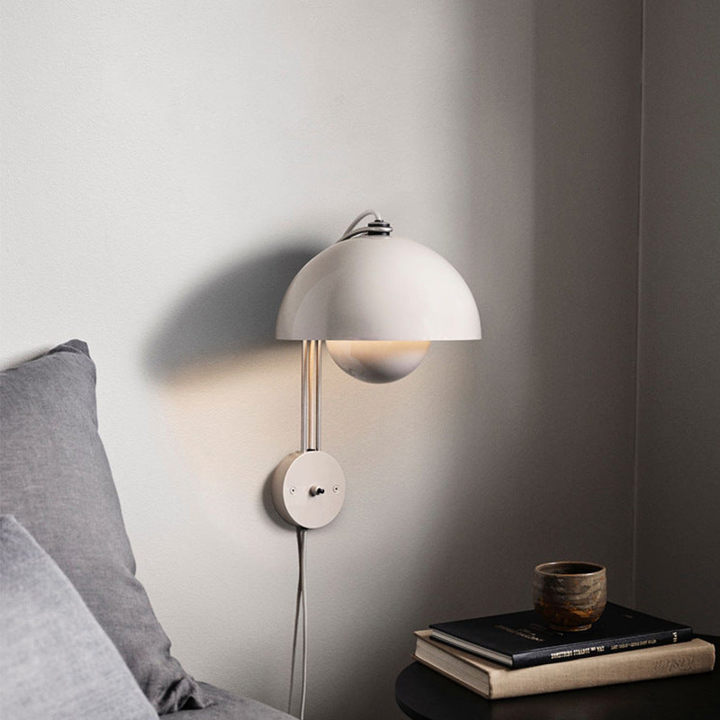 Blooming Grace Wall Lamp casting a warm glow in a stylish living room, highlighting its unique flower bud-inspired design and premium materials.