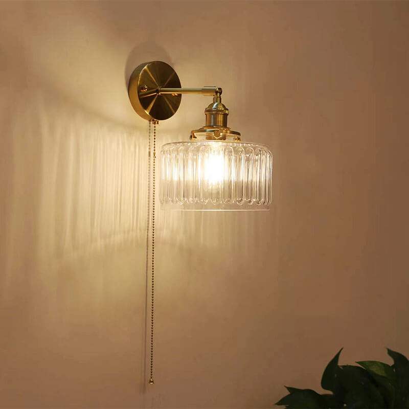 Clear Glass Wall Light LED with minimalist design, mounted above a bedside for cozy interior lighting.