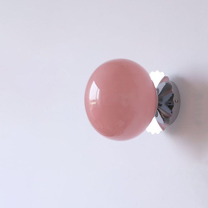 Modern, minimalist 1-light wall lamp made of iron glass with a round head in pink, beige, and white