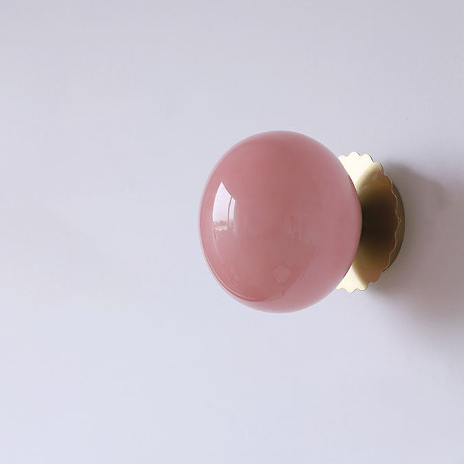 Modern, minimalist 1-light wall lamp made of iron glass with a round head in pink, beige, and white