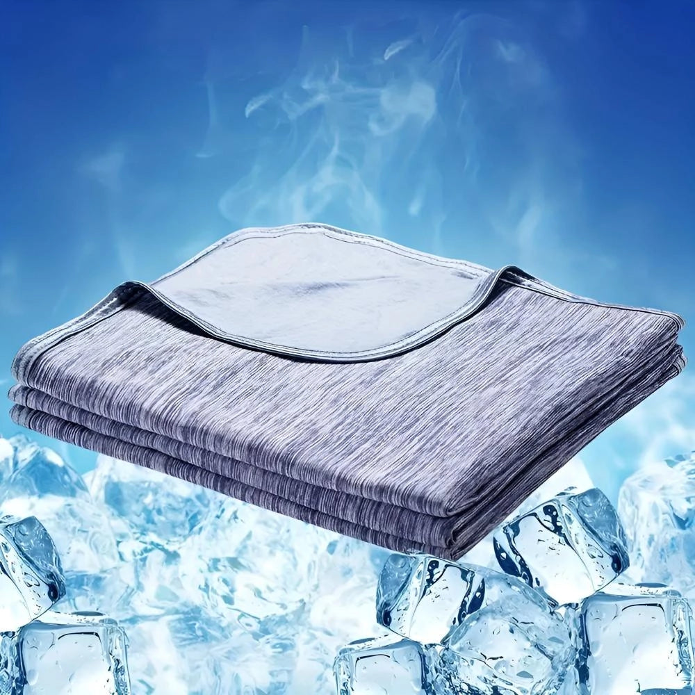 Cooling blanket displayed against a backdrop of clear blue sky with snowy mountain terrain, illustrating its quick cool down and temperature regulation features.