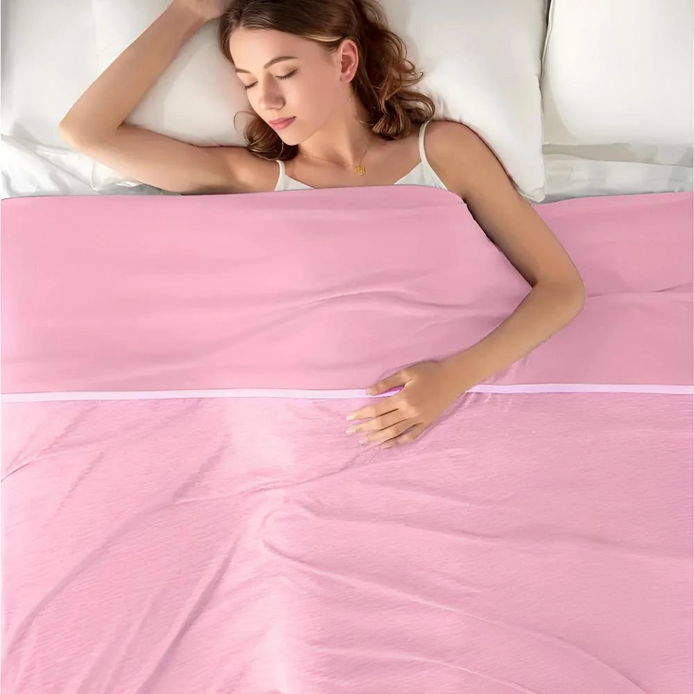 Pink cooling blanket on a bed, designed for quick cool down and temperature regulation, suitable for a single-sized bed.