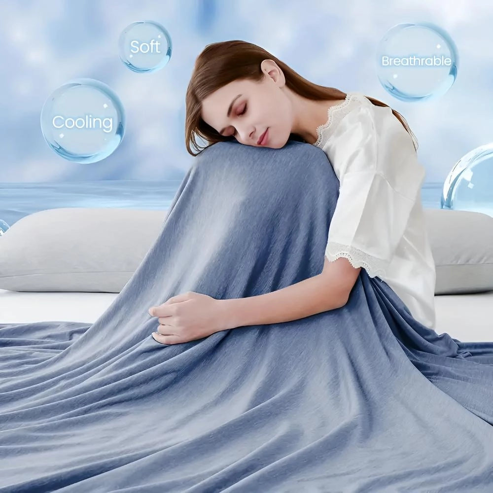 Navy blue 400TC cooling blanket draped over a bed, showcasing its soft and breathable fabric ideal for quick cool down and temperature regulation.