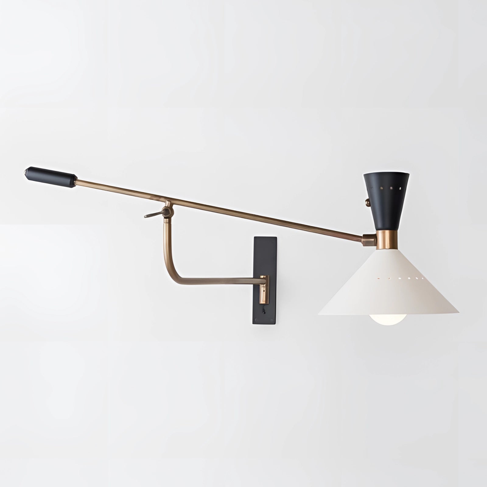 Adjustable brass wall sconce with a modern mid-century design, featuring a swing arm light fixture against a wooden background, highlighting metal components and a sleek aesthetic.