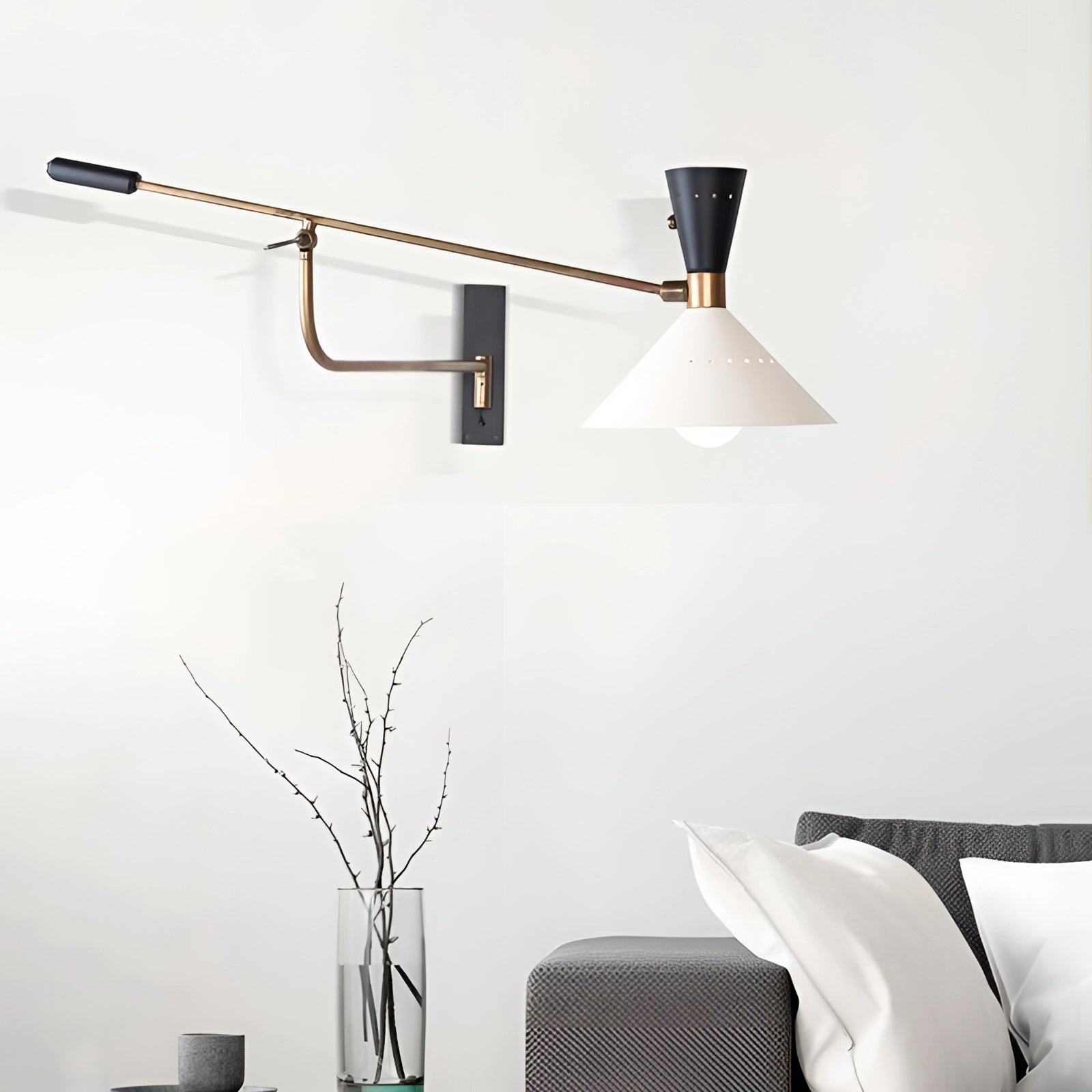 Adjustable brass wall sconce featuring a modern mid-century swing arm design, mounted on a grey wall next to a wooden table, showcasing elegant lighting suitable for interior design.