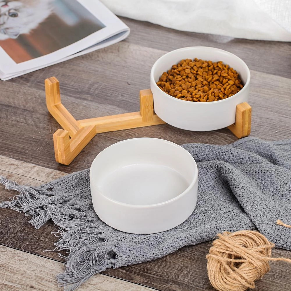 Adjustable multi-level bamboo pet feeder with colorful dishes, showcasing wooden structure with vibrant dishware designed for serving pet food.