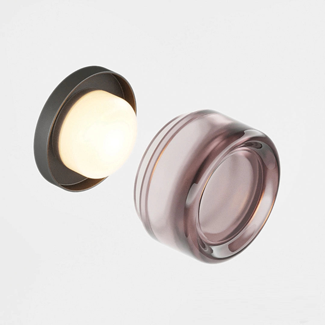 Modern minimalistic round ceiling lamp with amber glass, featuring a sleek metal design and circular shape.