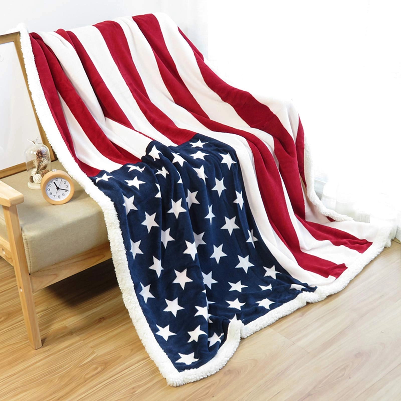 American flag fleece blanket featuring a patriotic stars and stripes design, sized 60 x 80 inches, displayed against a wooden background.