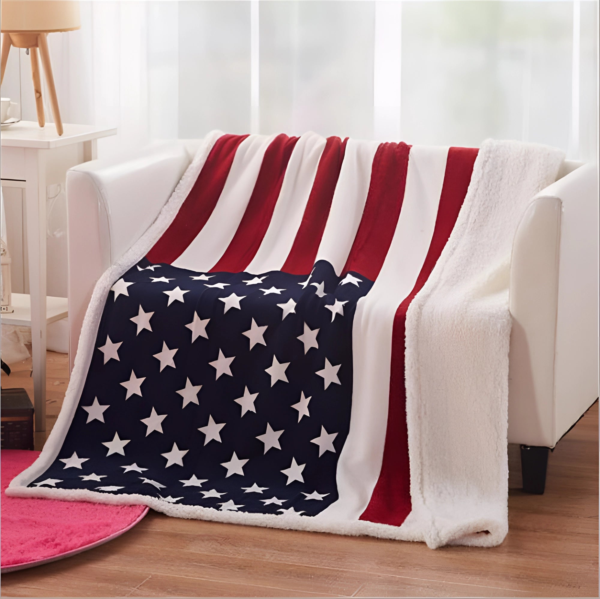 Cozy fleece blanket featuring a patriotic design with an American flag pattern, draped over a chair in a tastefully decorated interior space.