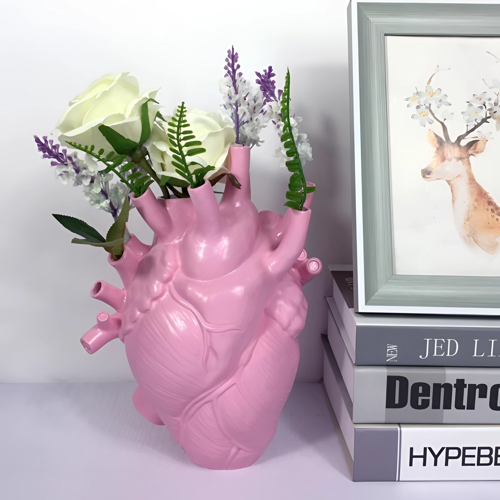 Pink large anatomical heart vase with intricate floral design, crafted from ceramic. The sculpture features a vibrant pink and purple color scheme, resembling a realistic heart shape, and is used as a decorative flowerpot.