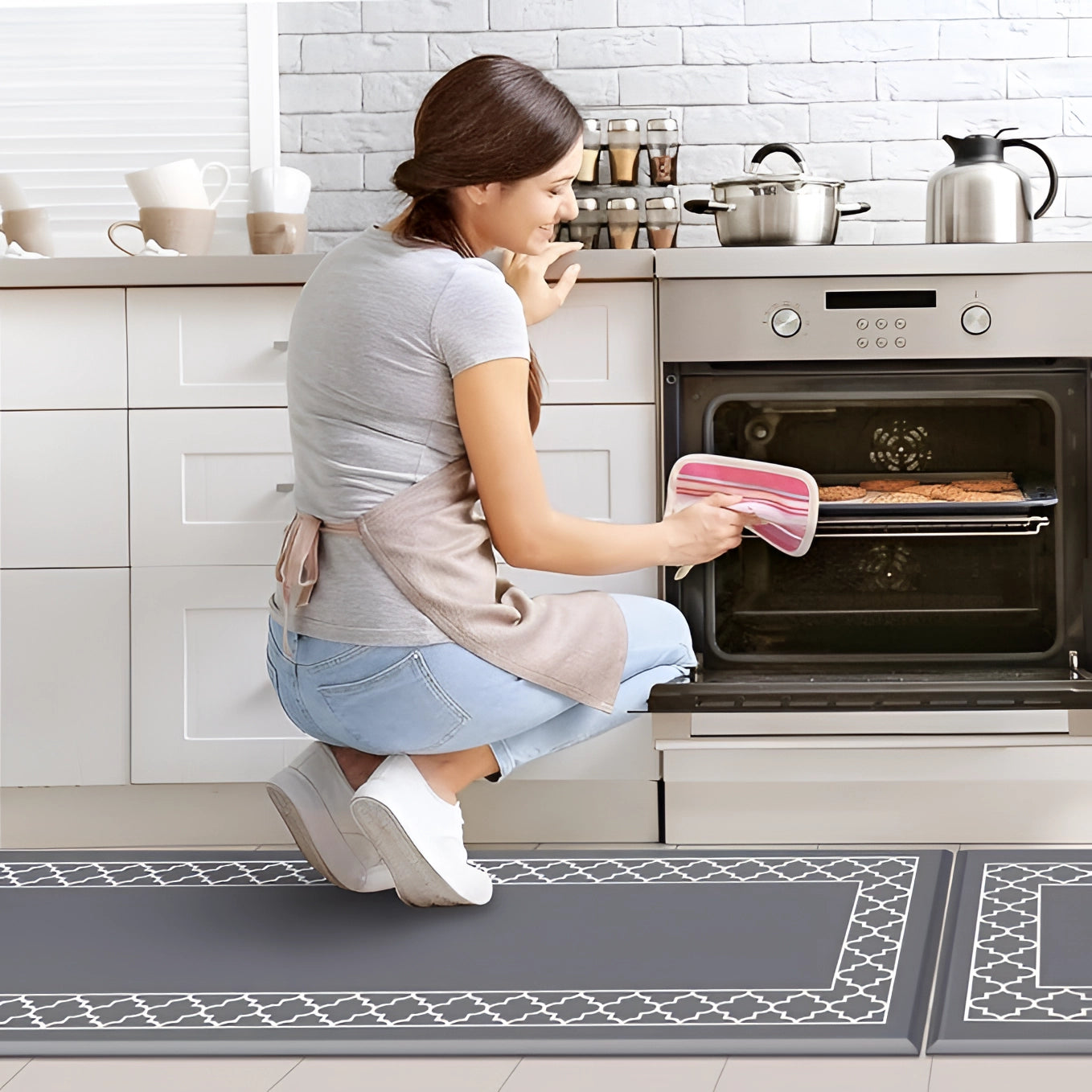 Ergonomic anti-fatigue cushioned kitchen mat placed on tiled floor in front of kitchen cabinetry, designed to provide support and comfort while standing, featuring a slip-resistant surface.