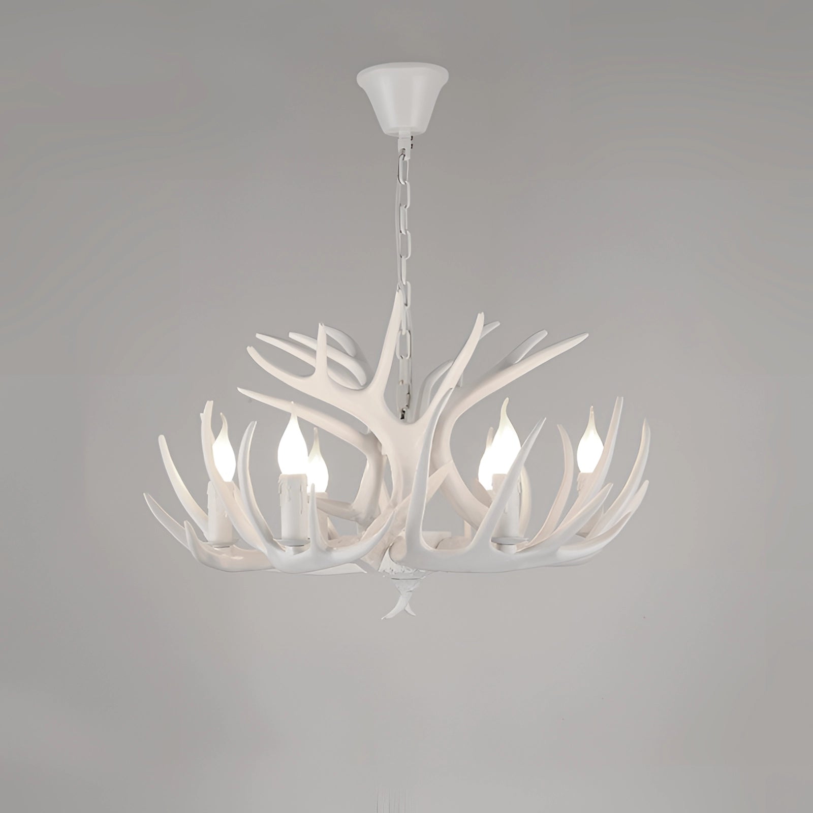 Antler chandelier in a rustic lodge style featuring a white finish with six lights, designed to be a ceiling fixture for cabin decor and interior design.