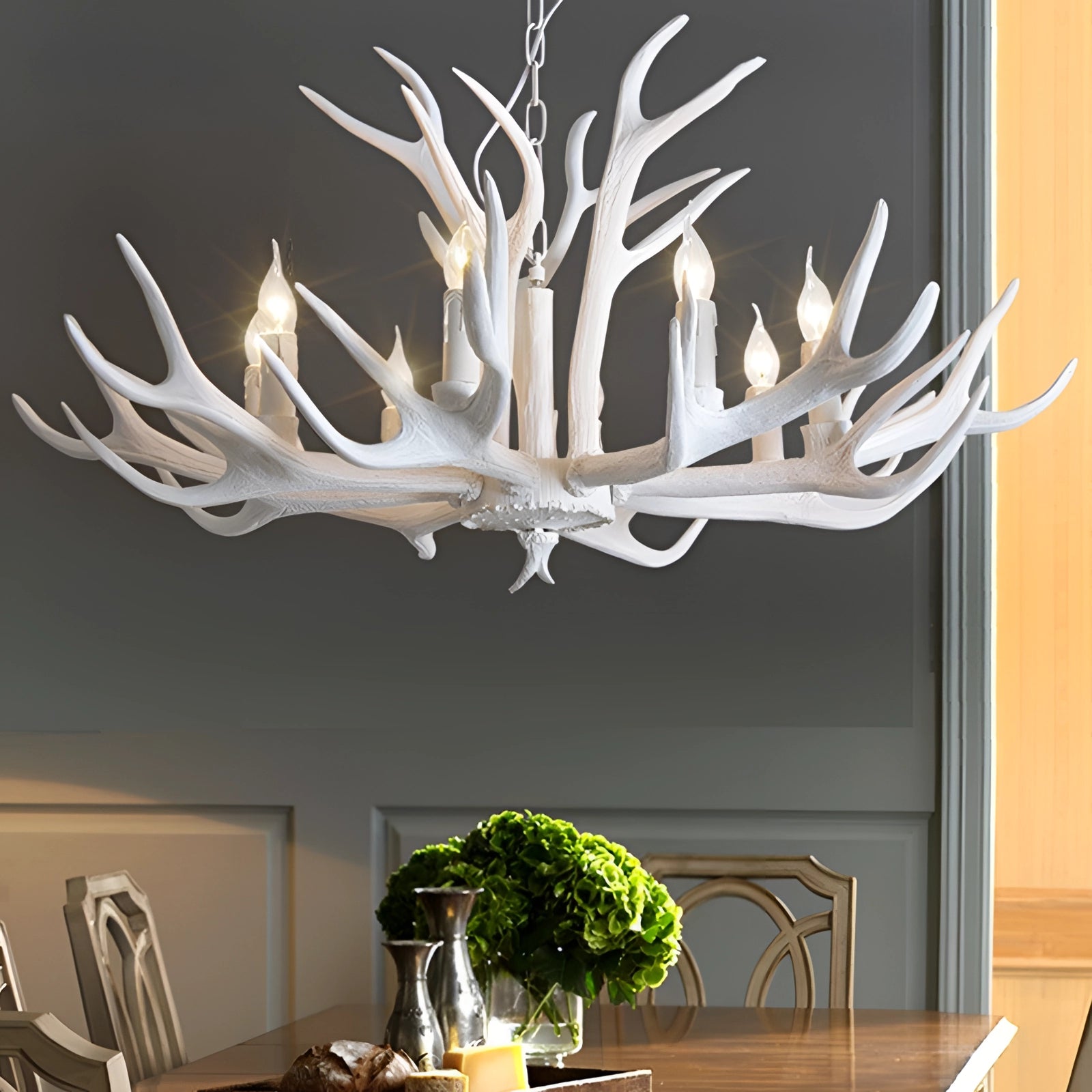 White antler chandelier with eight lights, designed as a rustic lodge cabin decor and lighting fixture, made from natural materials and styled to complement wooden furniture and interior design elements.