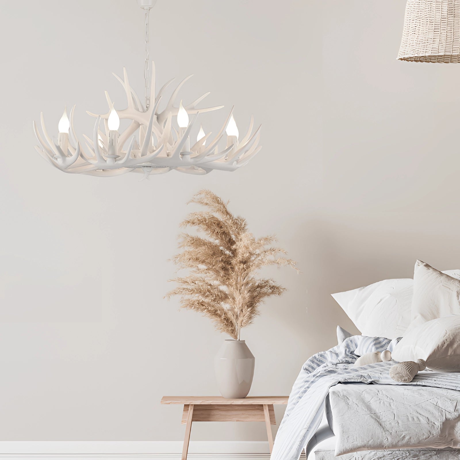 Antler chandelier with rustic lodge cabin decor, featuring natural wood materials and twig-like design, hanging in an interior setting against a grey wall.