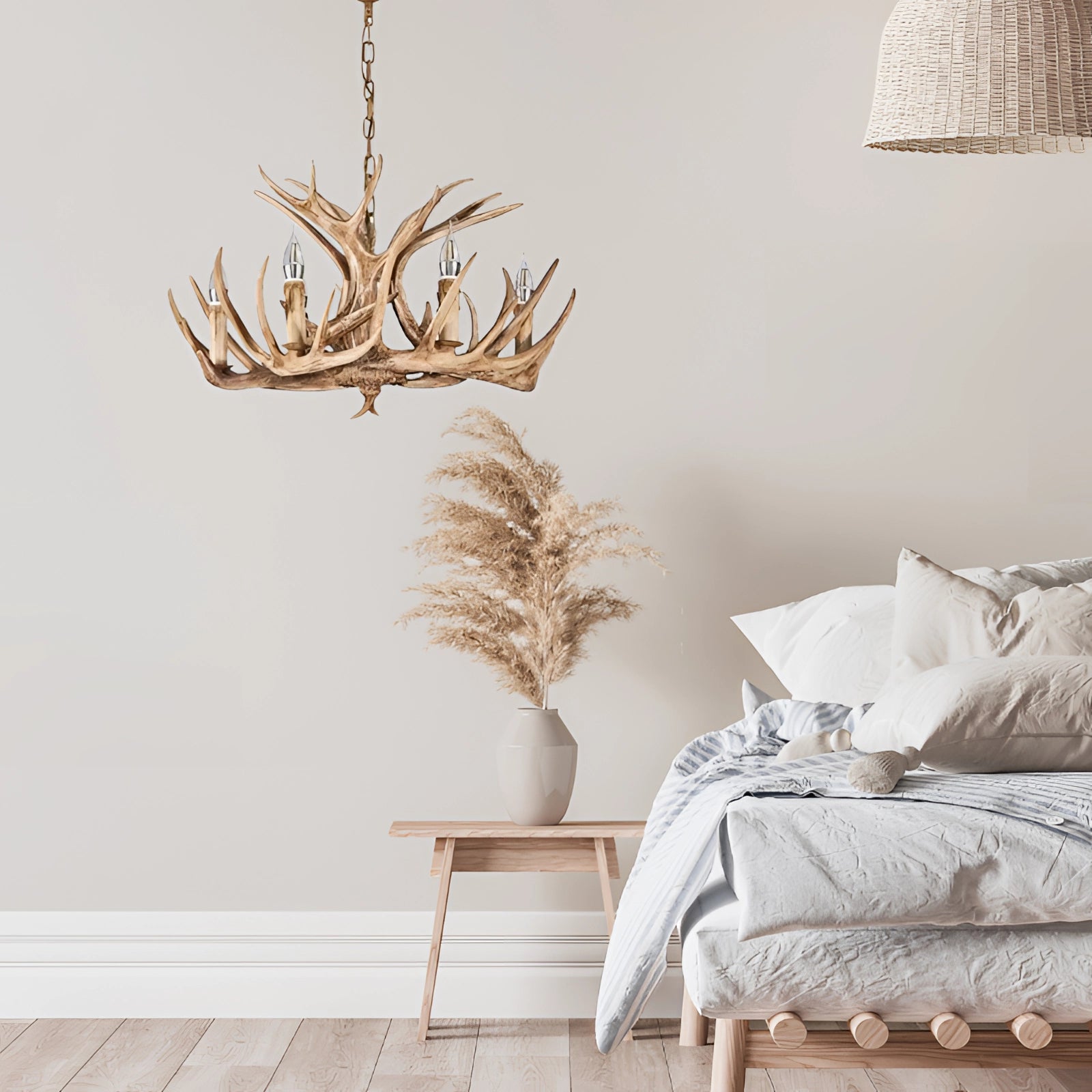 Antler chandelier with a rustic lodge design, featuring natural wood and twig elements, hanging in an interior setting.