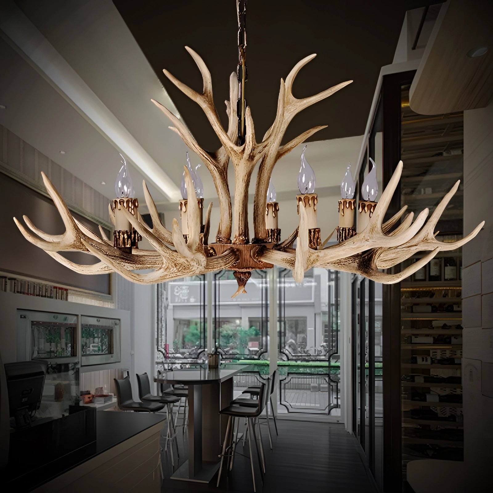 Antler chandelier with a rustic lodge cabin design featuring eight lights in a brown finish, hanging in an interior setting, enhancing the room's architectural and decorative elements.