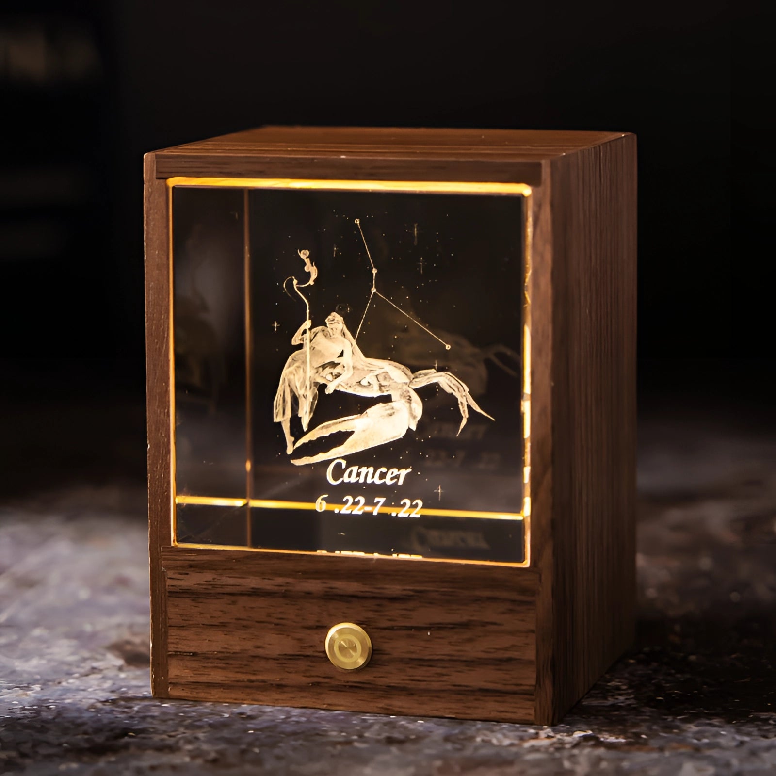 LED night light with a rectangular wooden base, featuring a personalized Cancer zodiac design, illuminated in a dark setting.