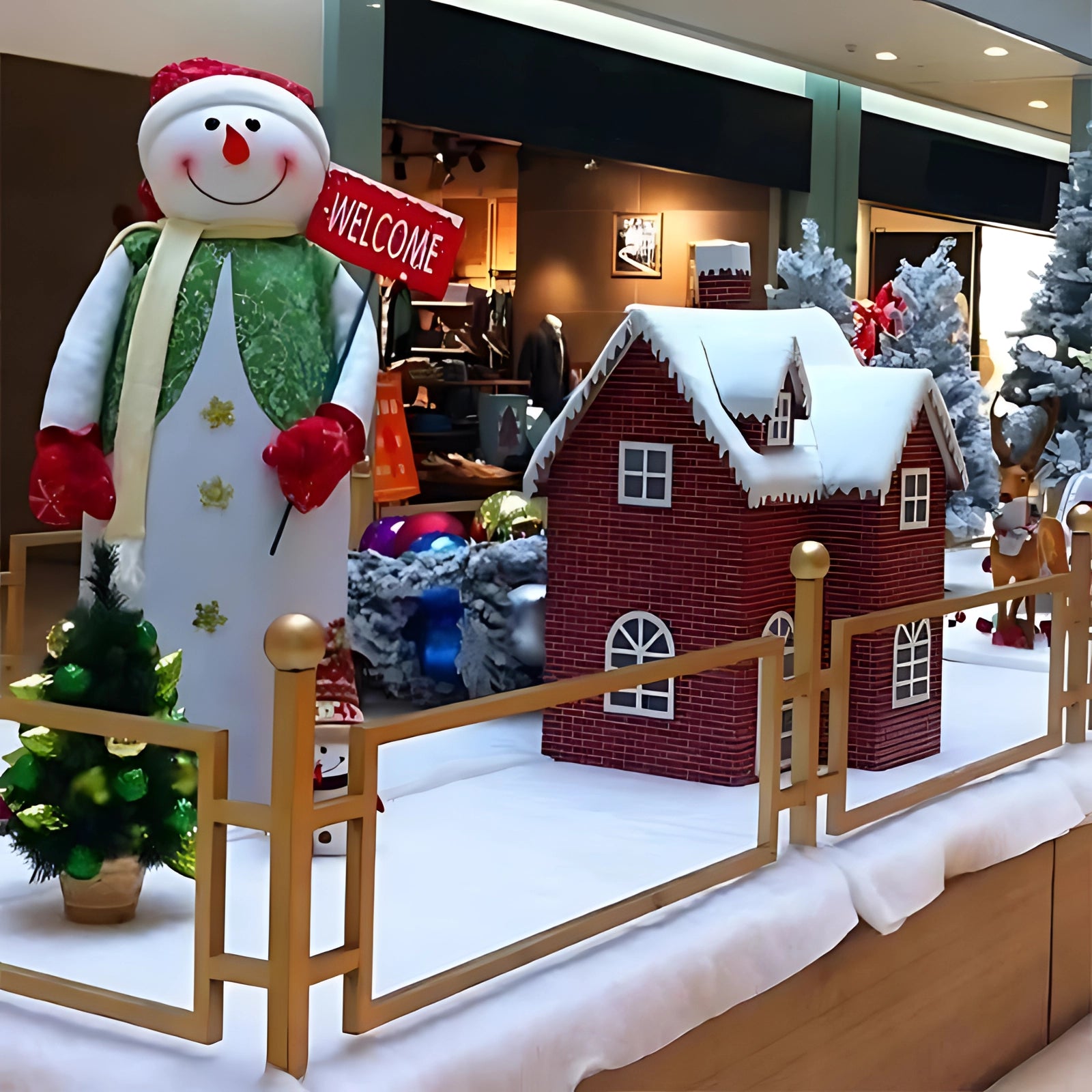 Artificial snow blanket used as a foundation for a holiday-themed setup featuring miniature trees, a snowman, and Christmas ornaments, simulating a festive winter village scene indoors.