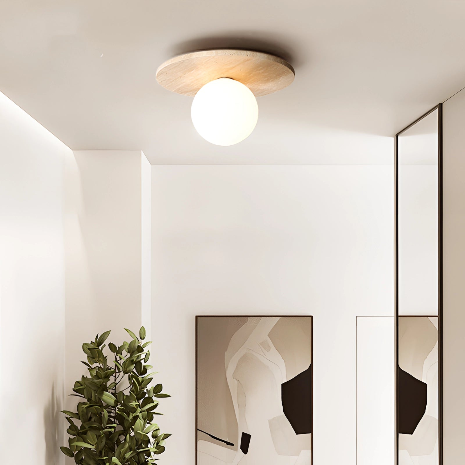 Artisan stone finish eco-friendly flush mount ceiling light with a G9 bulb, featuring a minimalist rectangular design in a white and wood finish, illuminated in an interior setting with houseplants.