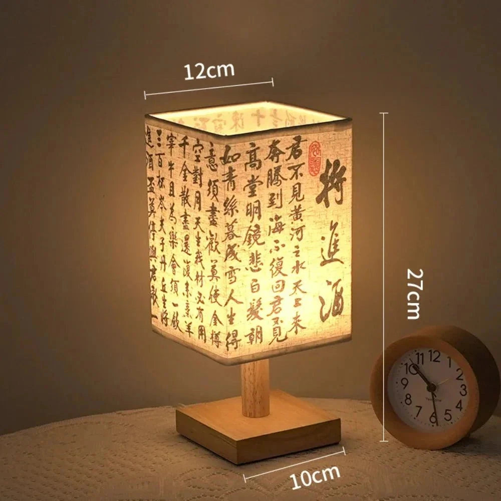 Asian calligraphy lamp with a rectangular wooden base, featuring intricate design elements on the light surface, shown with a USB connector, measuring 27cm in height.