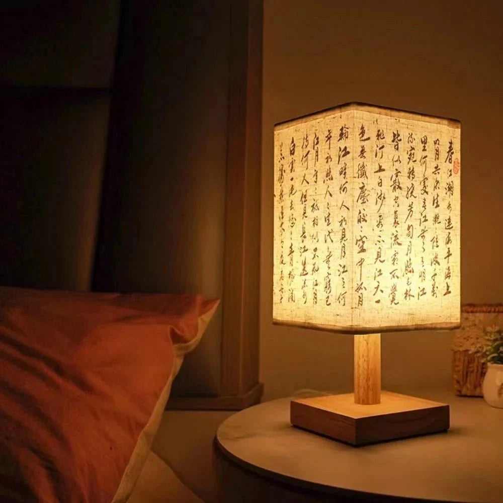 Asian calligraphy lamp with a wooden base, featuring elegant handwritten characters, compact design at 27cm tall, emits a warm and comforting glow, suitable as a nightlight, with a flowerpot-like structure and hardwood accents.