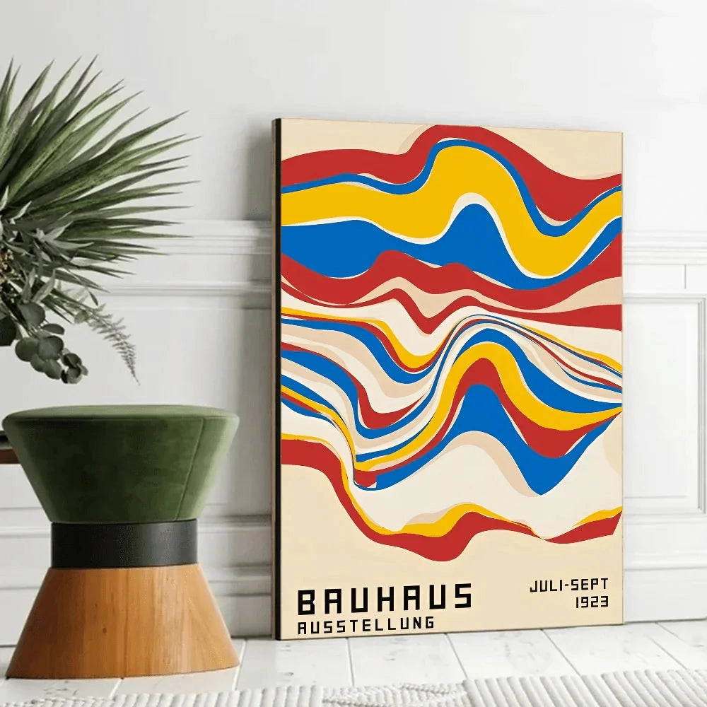 Bauhaus geometric art print on canvas featuring mid-century modern design with abstract shapes and patterns, displayed in a rectangular frame measuring 21 x 30cm. A small flowerpot with a houseplant is visible, complementing the artistic decor.