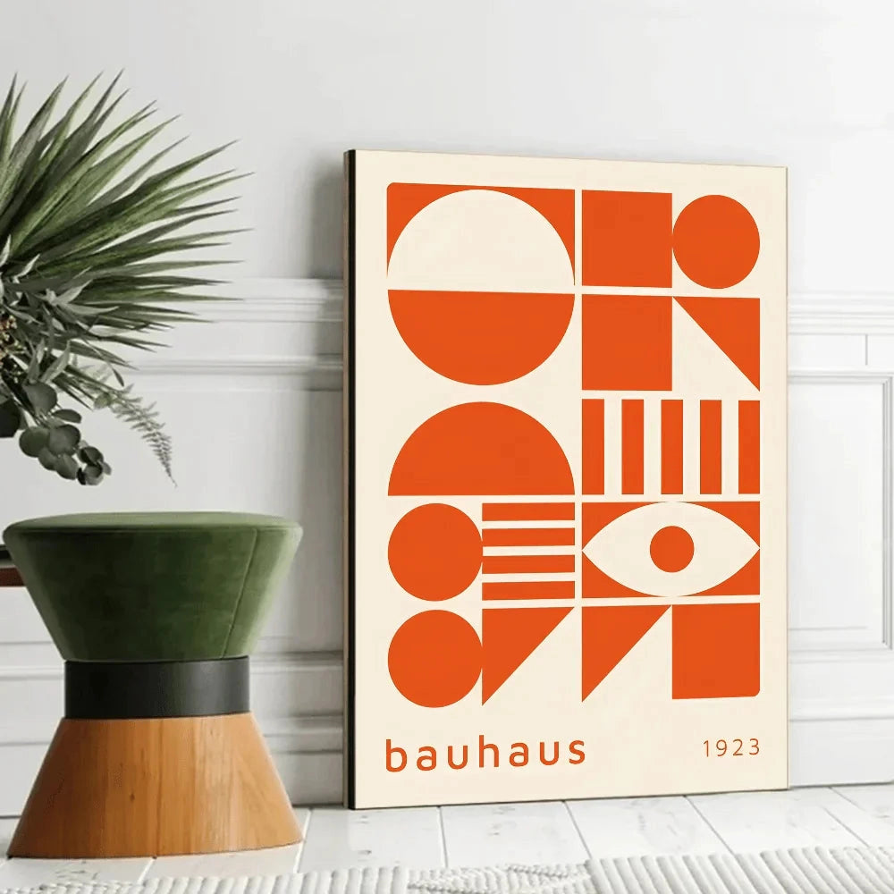 Bauhaus geometric art print featuring mid-century modern design with abstract orange and wood-toned shapes, displayed on a wall adjacent to a flowerpot with a houseplant.