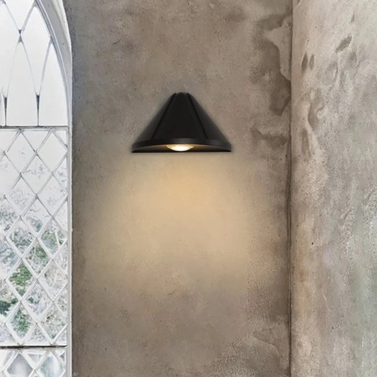 Modern minimalistic LED ceiling lamp with a black geometric pendant design, featuring wooden accents and a triangle-shaped shade, hanging in a contemporary interior with concrete and composite material elements.