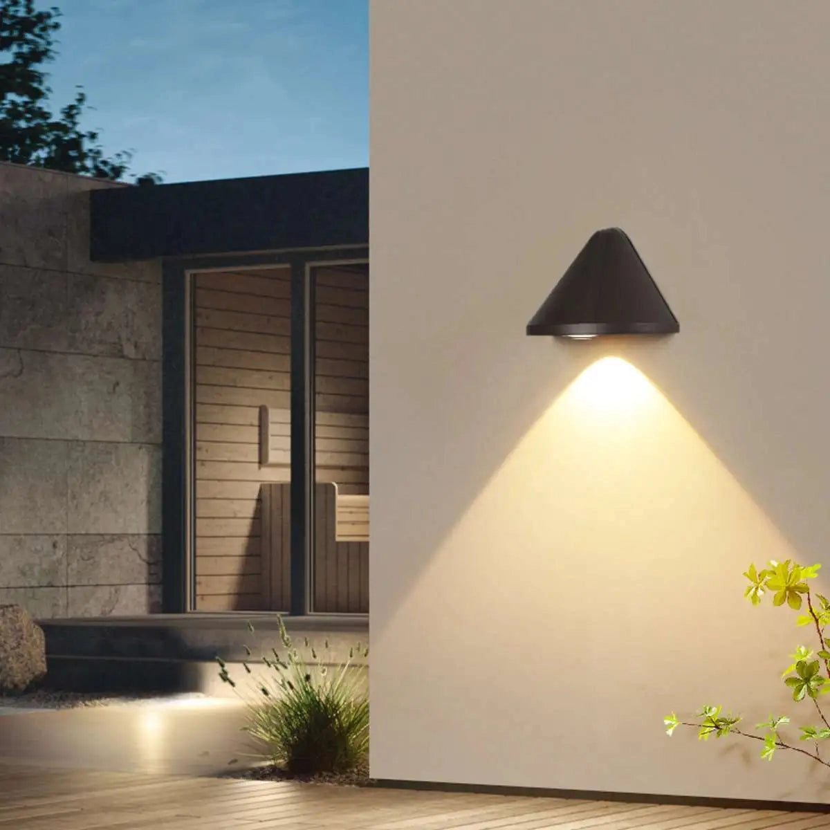 A modern black geometric pendant light with LED illumination, hanging from a ceiling, featuring a minimalistic design against a backdrop of wooden and plant elements.