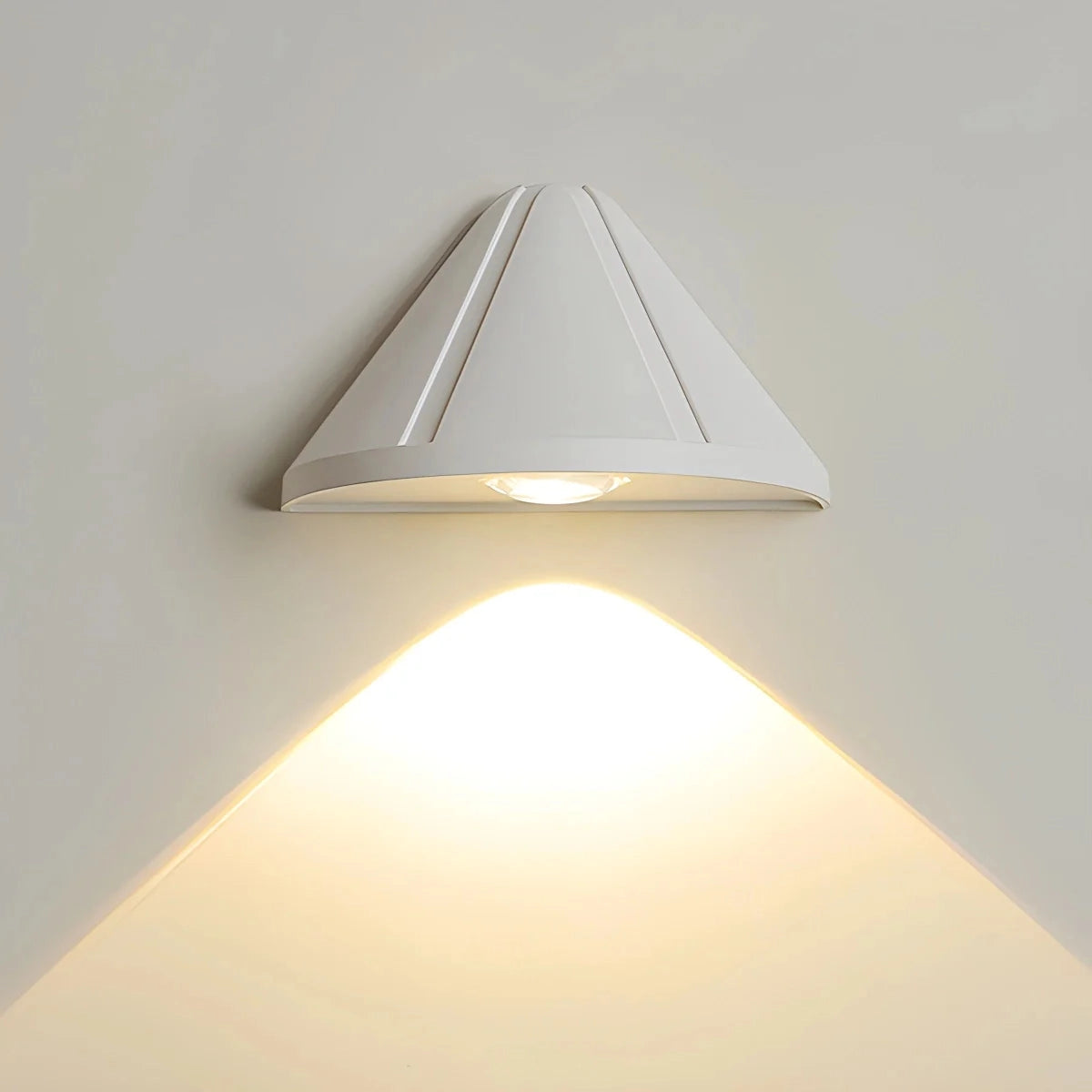 Modern minimalistic LED ceiling lamp with a black geometric design, featuring triangular and rectangular shapes, suspended from a sand white ceiling fixture.