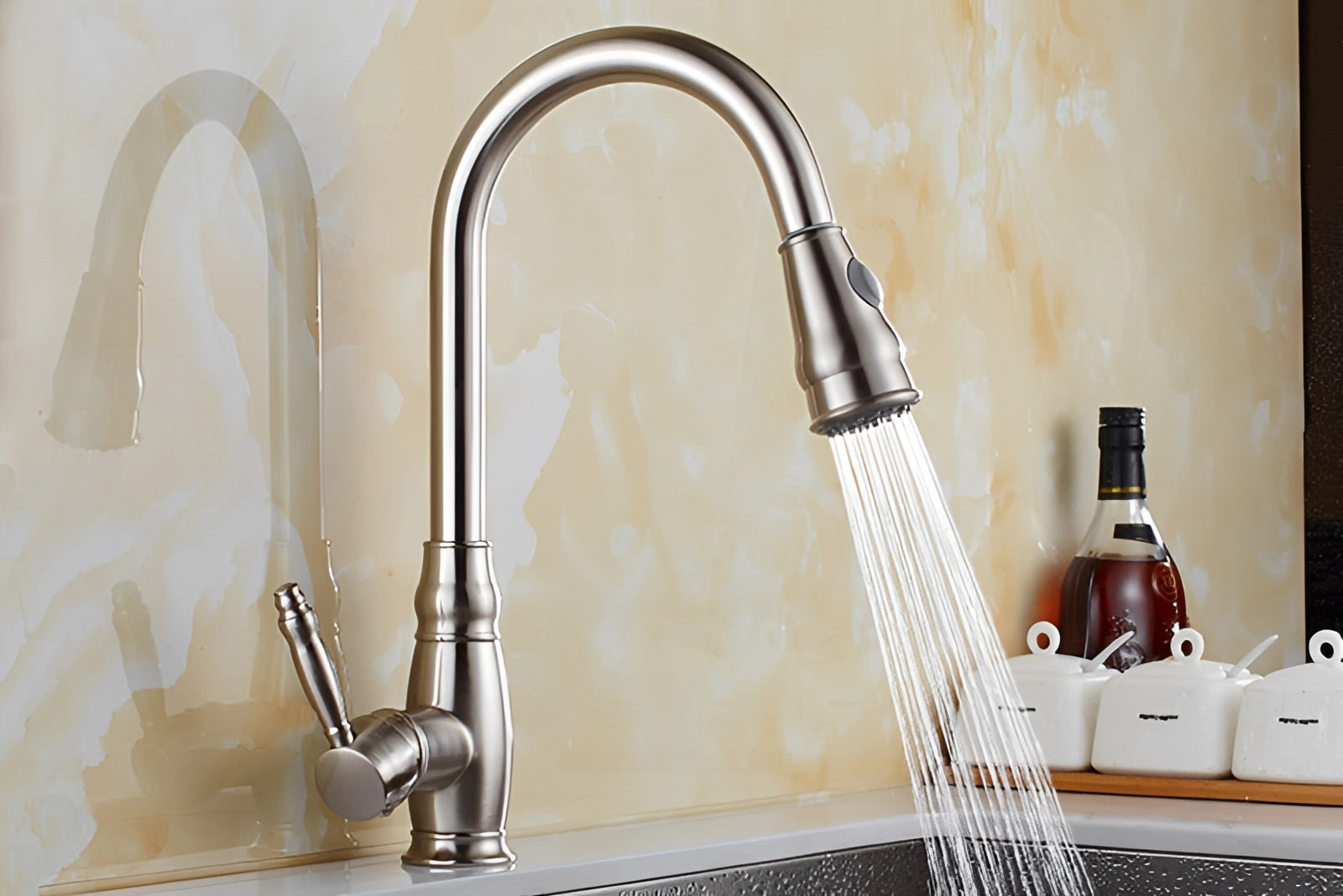 Black kitchen faucet with a pull-down sprayer and single handle, installed over a sink with eco-friendly design elements.