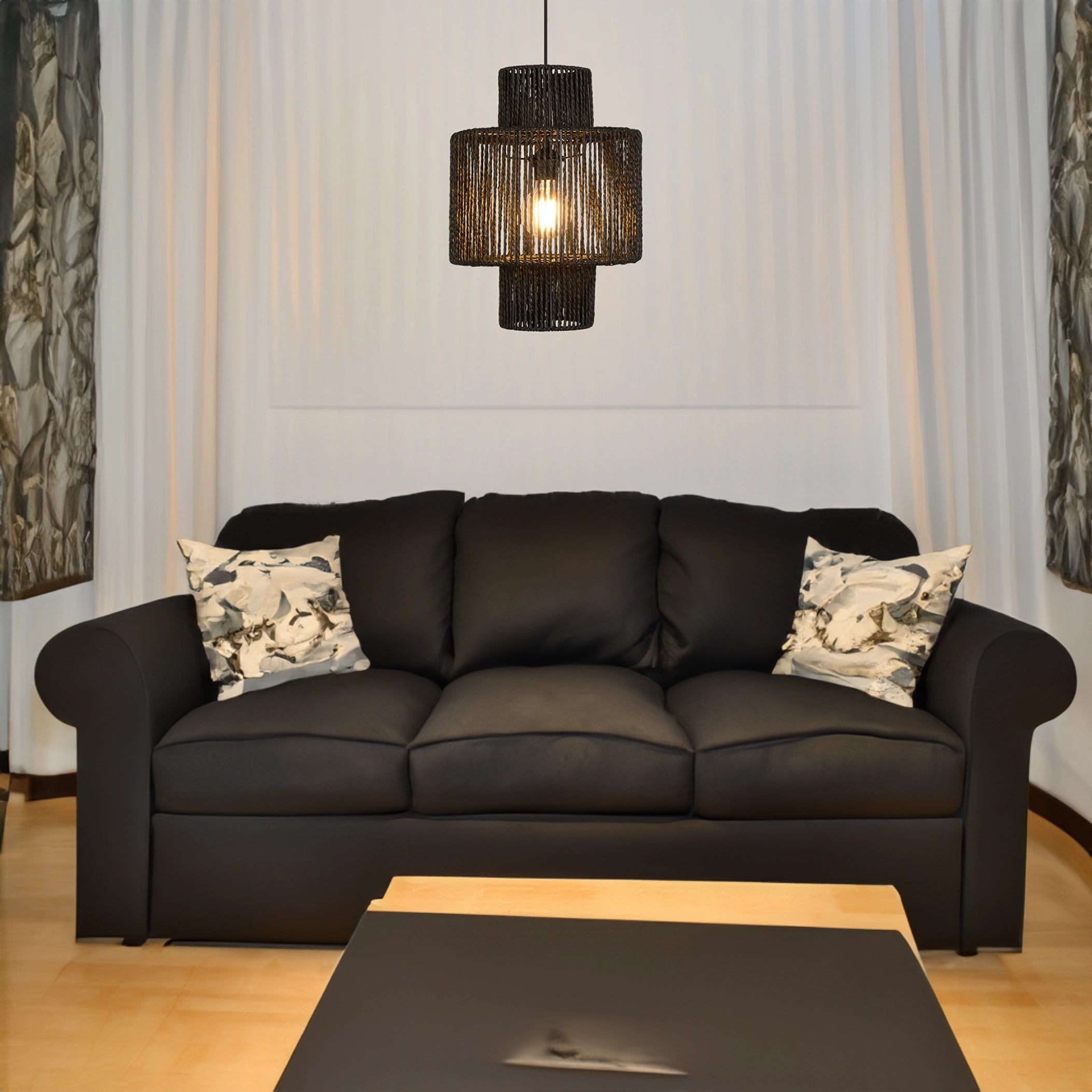 Black Rattan Woven Pendant Light hanging above a cozy living room setting with a brown couch and wooden table, showcasing contemporary eco-friendly design.