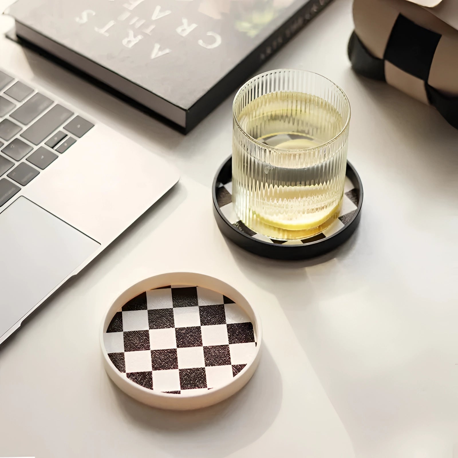 A small black and white checkered ceramic trinket dish, measuring 10cm, designed for holding jewelry or small items.