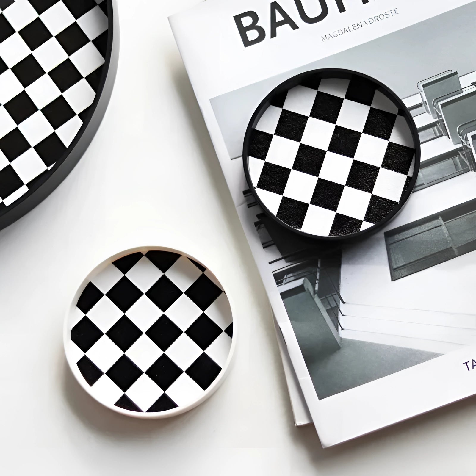 Black and white checkered ceramic trinket dish with a circular shape, designed for holding jewelry, measuring 10cm in diameter.