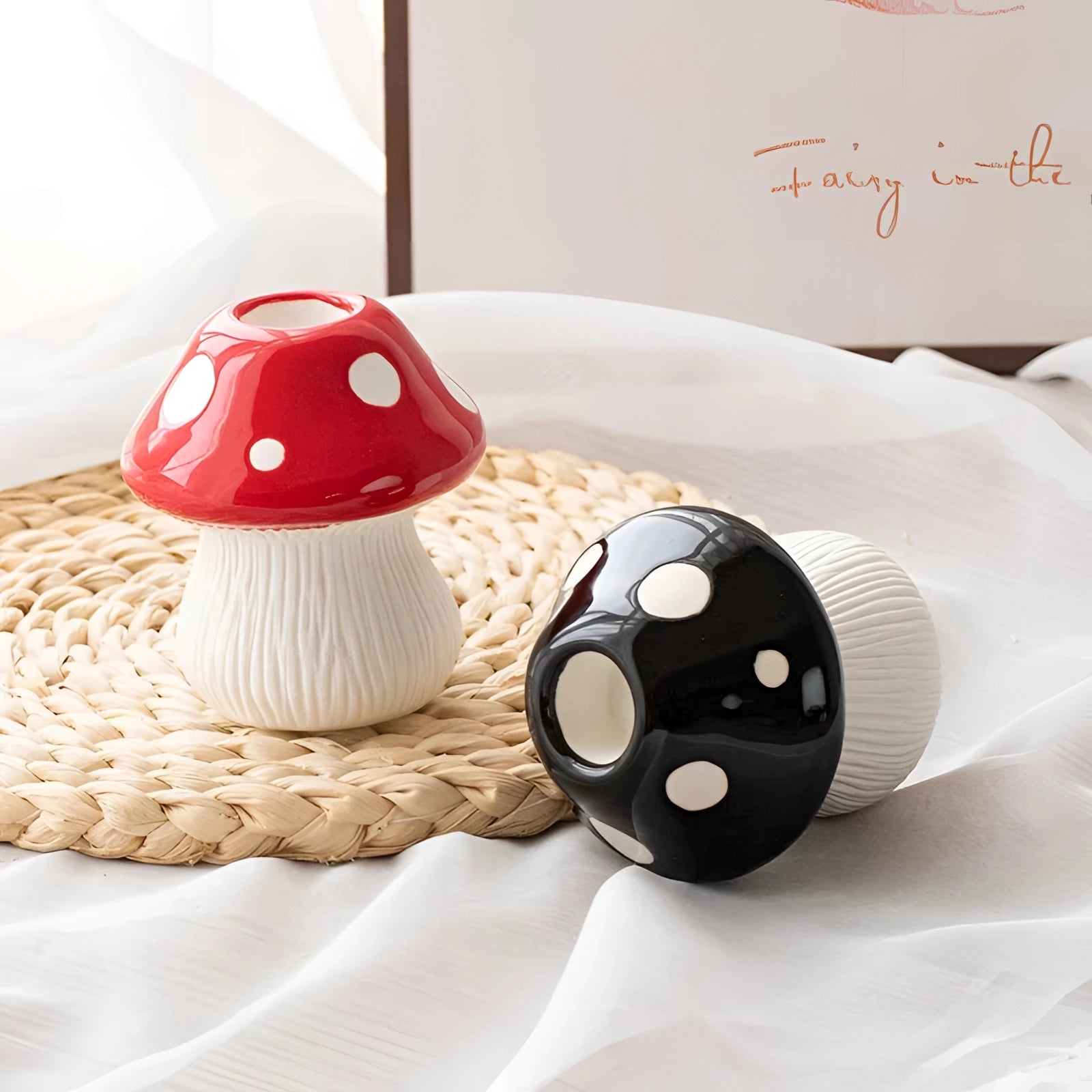 Black and white polka dot ceramic mushroom-shaped table lamp placed on a wooden surface.