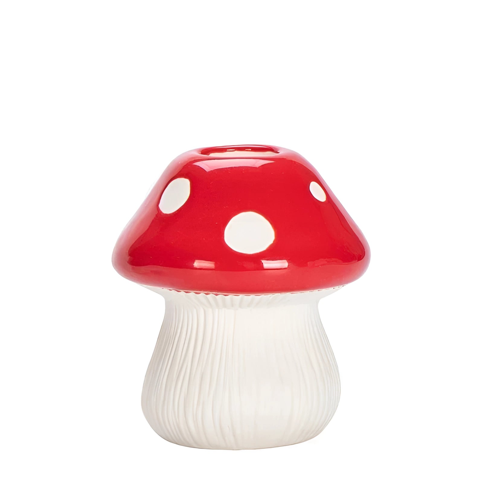 Black and white polka dot ceramic mushroom table lamp with a whimsical design, placed on a wooden table surface.