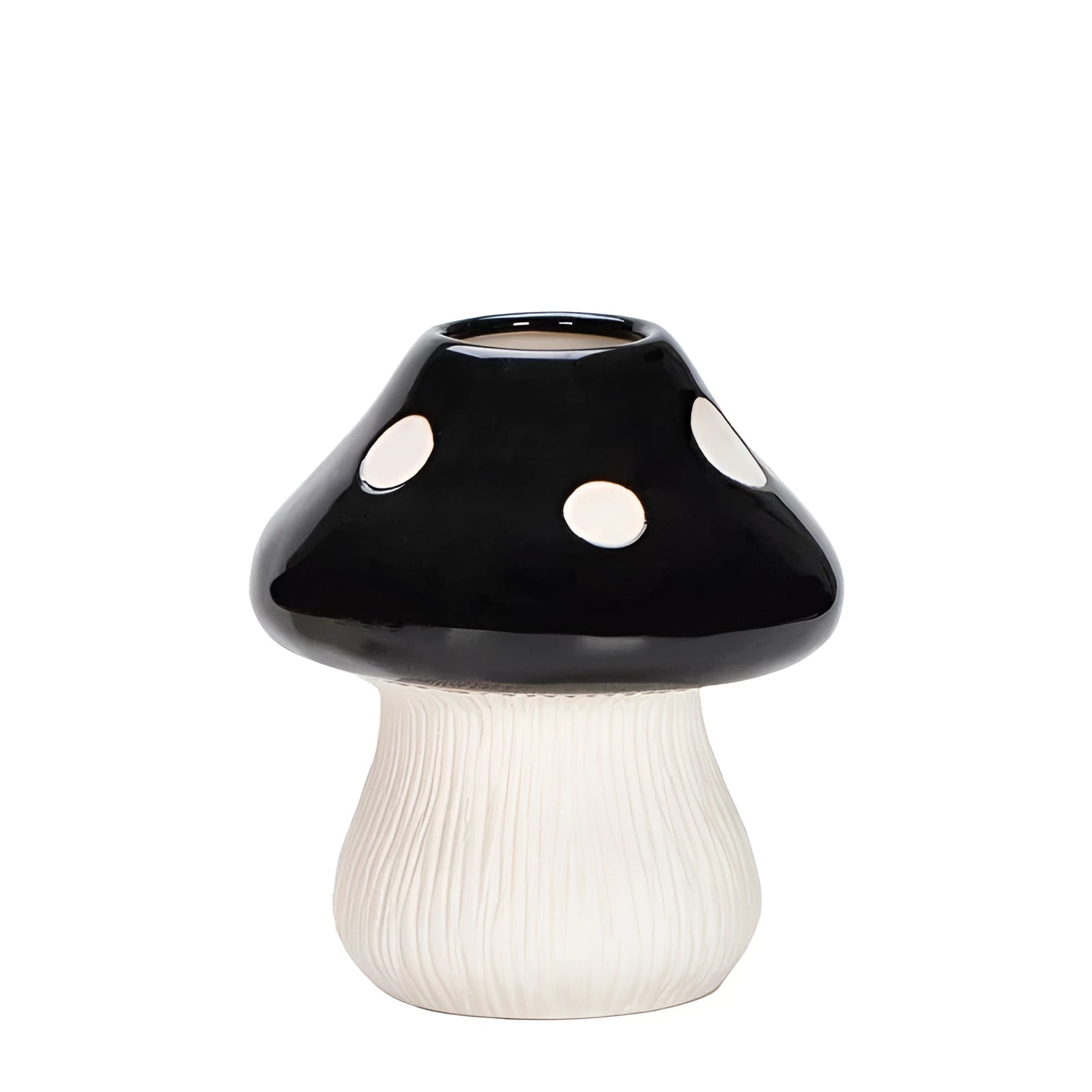 A black and white polka dot ceramic table lamp designed in the shape of a whimsical mushroom.