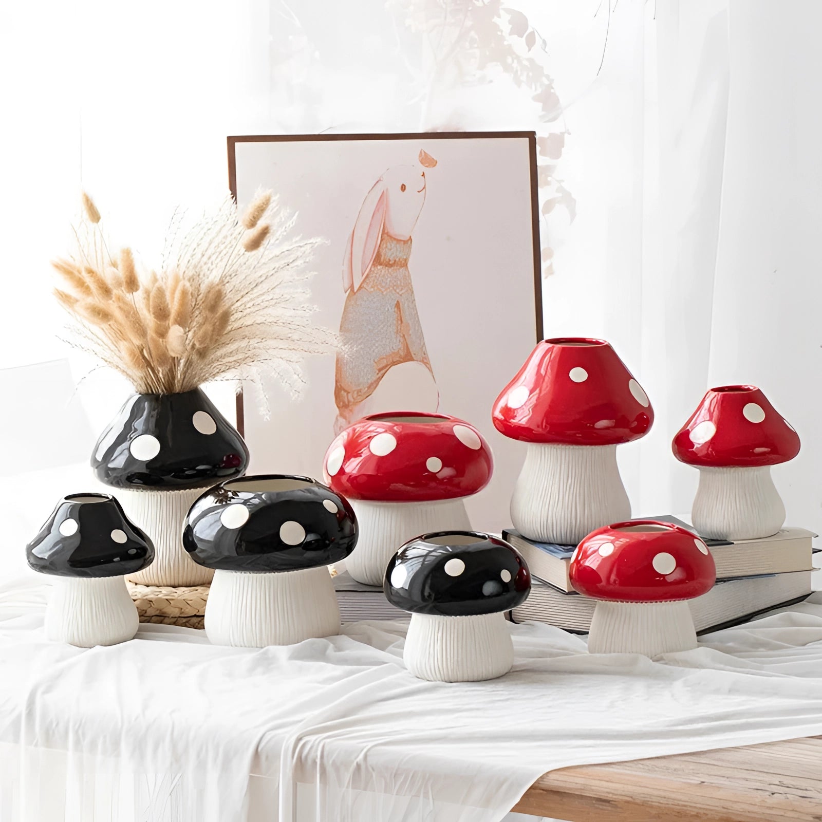 Black and white polka dot ceramic mushroom table lamp with a whimsical design displayed on a small table.