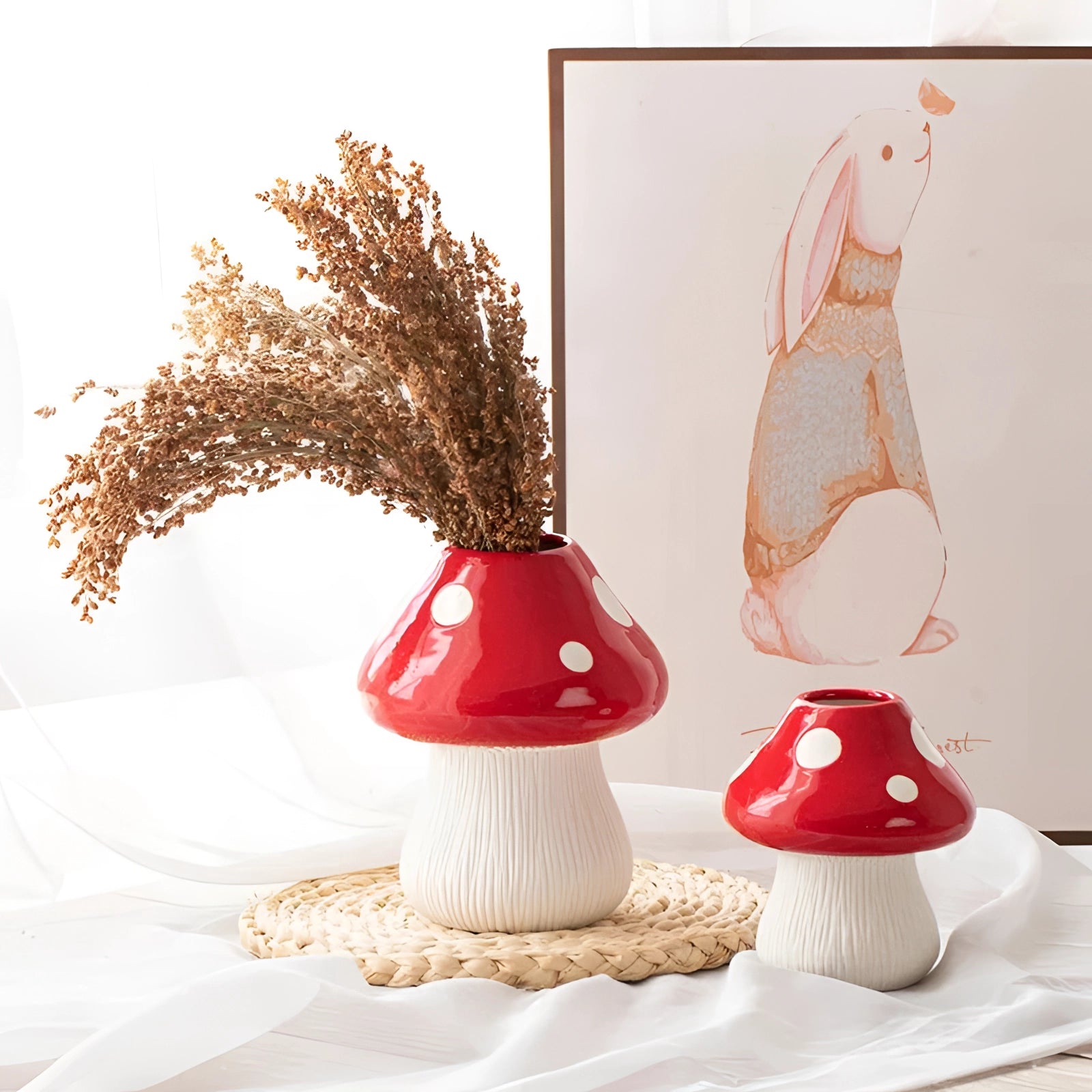 A black and white polka dot ceramic mushroom table lamp sitting on a wooden table, designed as whimsical decor with a playful and artistic appearance.