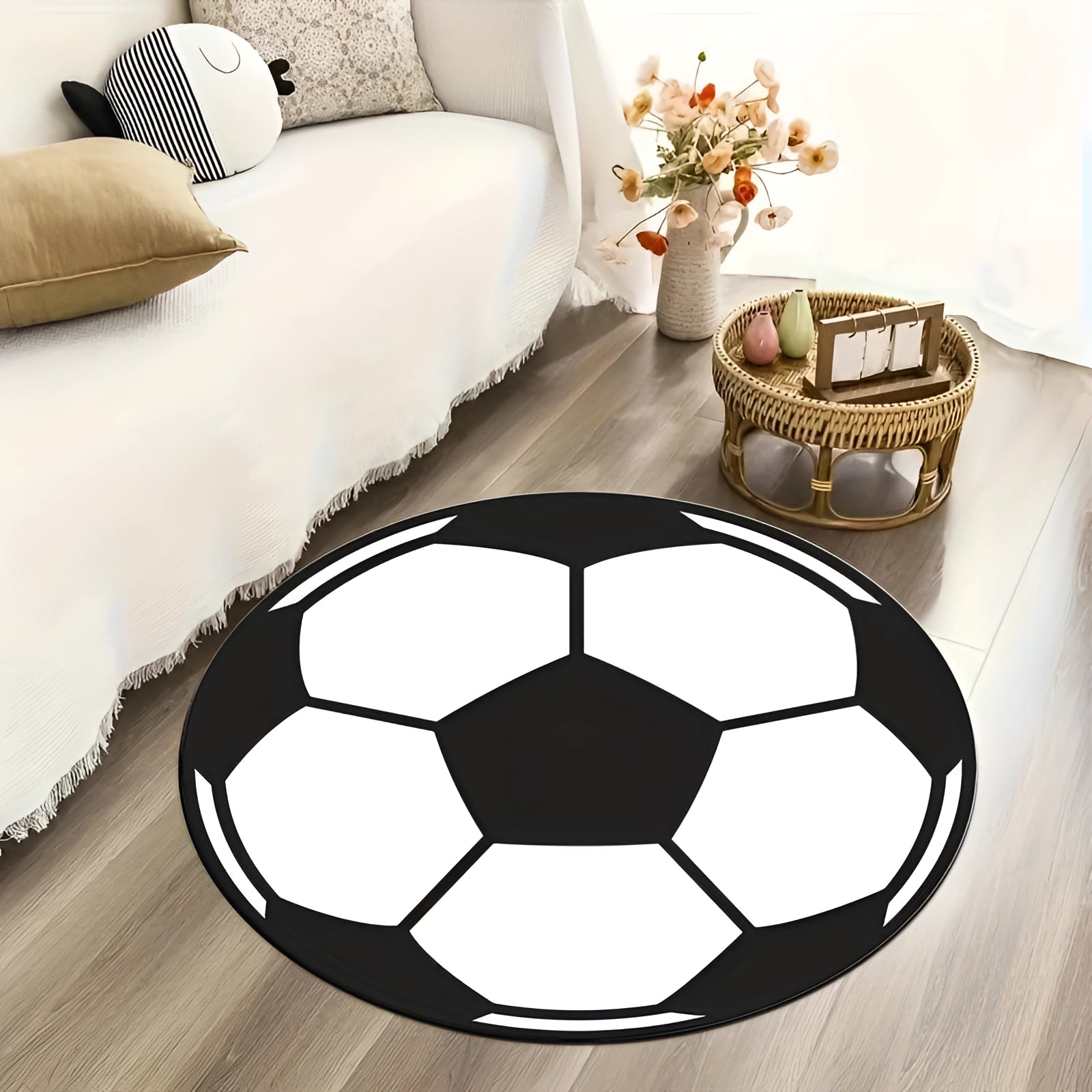 A 100cm black and white soccer ball rug designed for kids' room decor, featuring a round shape with alternating black and white panels resembling a classic soccer ball, placed on a wooden floor near a couch.