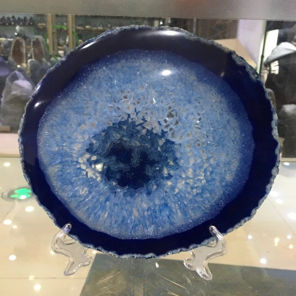 Blue agate geode plate with intricate electric blue patterns, circular in shape, serving as a luxurious stone for both serving and home decor.