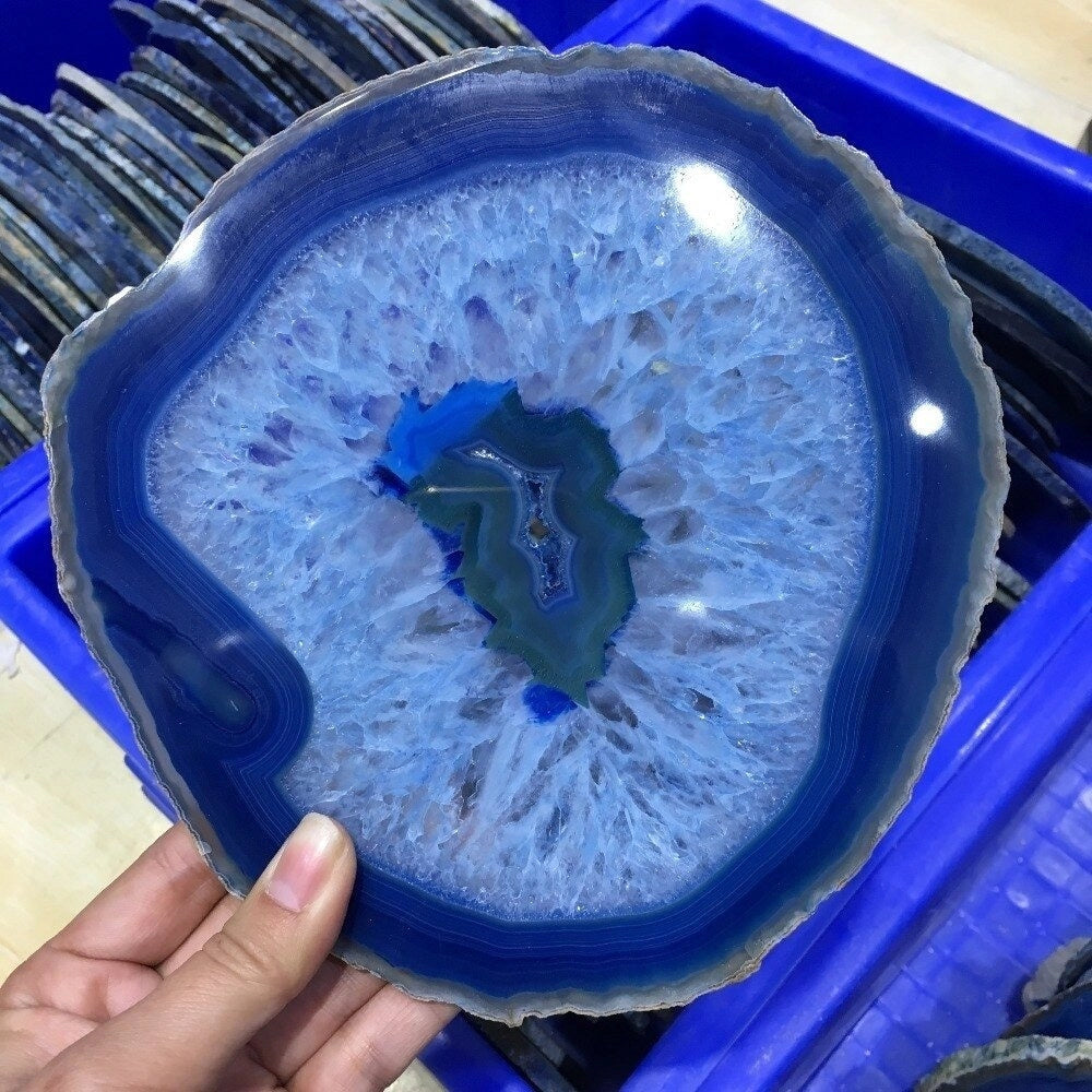 Blue agate geode plate with a striking crystalline pattern and rich blue hues, designed for use as a luxurious serving dish or stylish home decor piece.